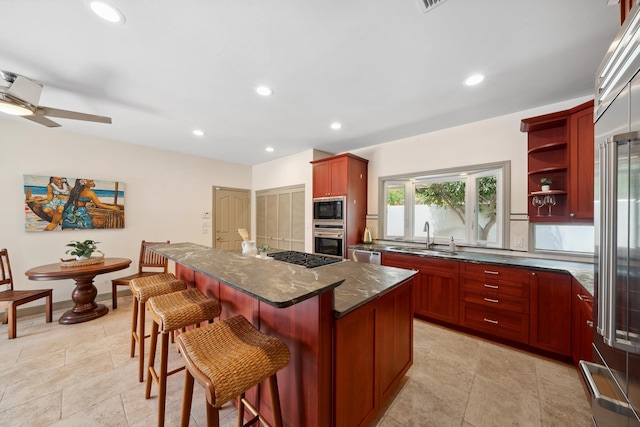 70 Pukolu Way, Kihei, HI 96753 - kitchen with stainless steel appliances, a sink, dark brown cabinets, a kitchen island, and recessed lighting