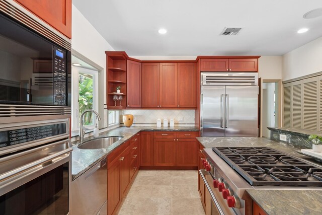 70 Pukolu Way, Kihei, HI 96753 - kitchen with built in appliances, a sink, dark stone countertops, open shelves, and decorative backsplash