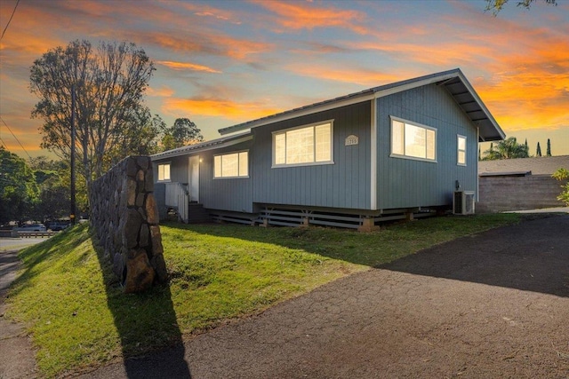 property exterior at dusk with a yard