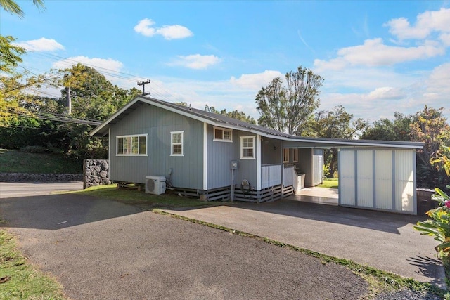 view of front of home featuring a carport and ac unit