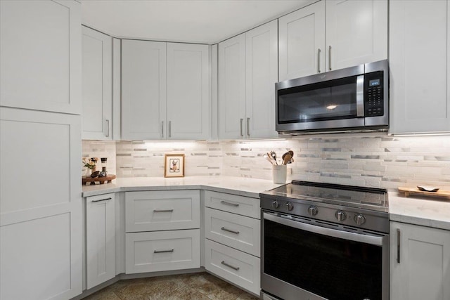 3150 Wailea Alanui Dr Unit 3007, Kihei, HI 96753 - kitchen with appliances with stainless steel finishes, white cabinets, tasteful backsplash, and light stone counters