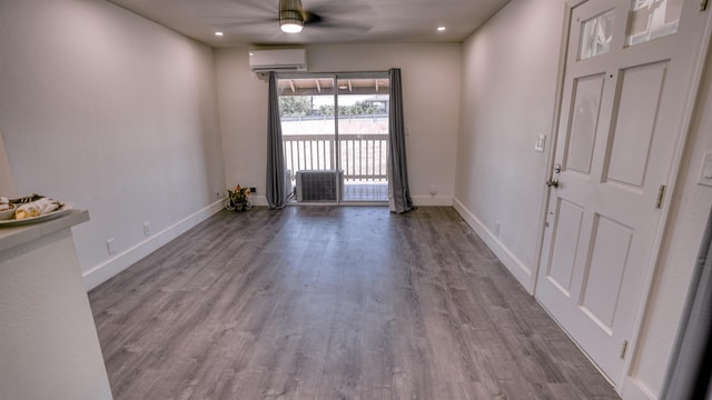 140 Uwapo Rd Unit 2-202, Kihei, HI 96753 - unfurnished room with a wall mounted AC, a ceiling fan, wood finished floors, and recessed lighting