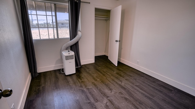 140 Uwapo Rd Unit 2-202, Kihei, HI 96753 - unfurnished bedroom featuring dark wood-style flooring and a closet