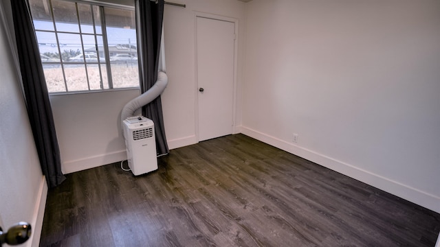 140 Uwapo Rd Unit 2-202, Kihei, HI 96753 - unfurnished bedroom with baseboards and dark wood-style floors