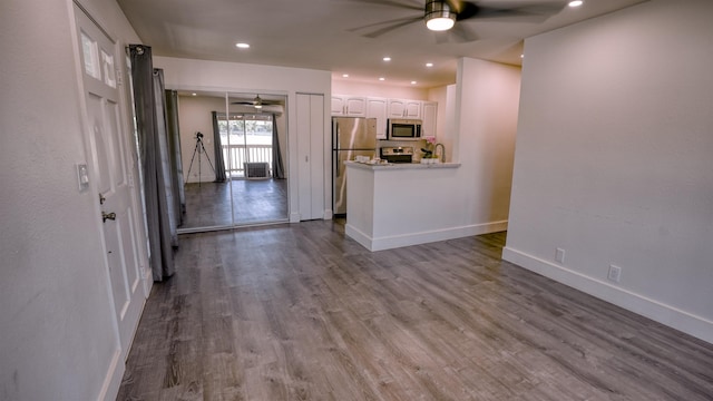 140 Uwapo Rd Unit 2-202, Kihei, HI 96753 - unfurnished living room featuring a ceiling fan, wood finished floors, and recessed lighting