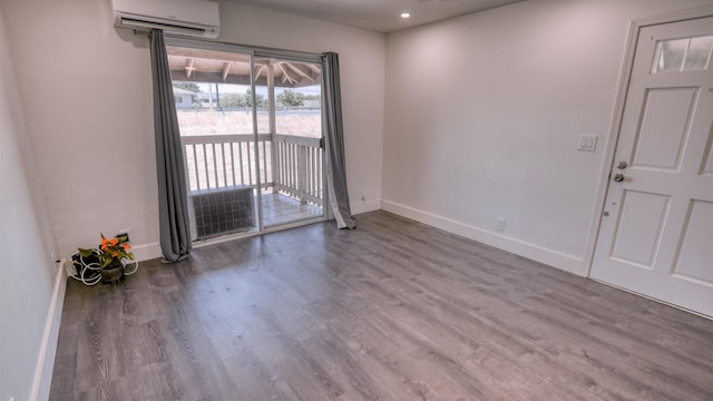 140 Uwapo Rd Unit 2-202, Kihei, HI 96753 - unfurnished room featuring a wall unit AC, wood finished floors, and recessed lighting