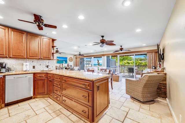 kitchen with light stone counters, light tile floors, sink, stainless steel dishwasher, and ceiling fan