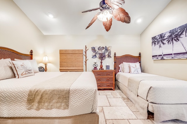 bedroom with light tile floors, ceiling fan, and vaulted ceiling