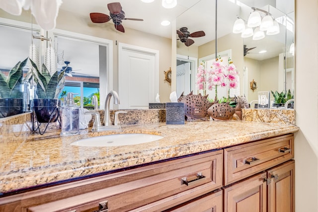 bathroom with ceiling fan and vanity