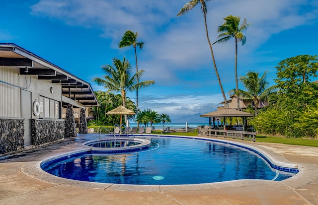 view of swimming pool with a gazebo and an in ground hot tub