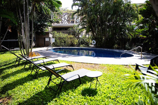 view of pool with a lawn, fence, and a fenced in pool