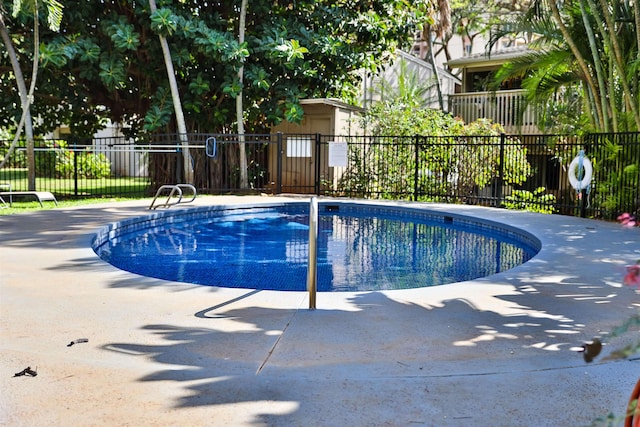 view of pool featuring a patio area, fence, and a pool