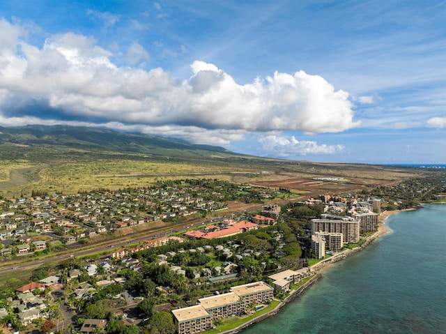 birds eye view of property with a water and mountain view