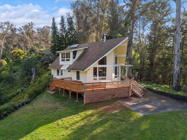 back of house featuring a yard and a deck