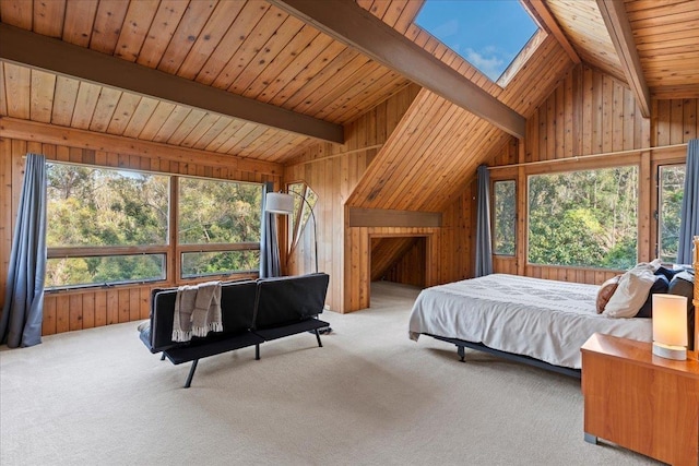 carpeted bedroom with wood ceiling, wooden walls, and lofted ceiling with skylight