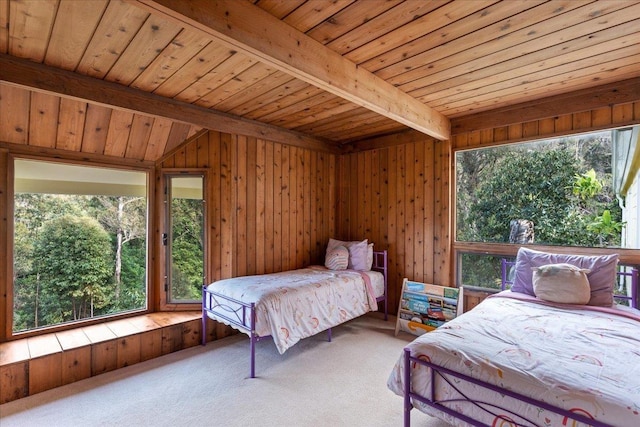 bedroom with wood ceiling, beam ceiling, carpet floors, and wood walls