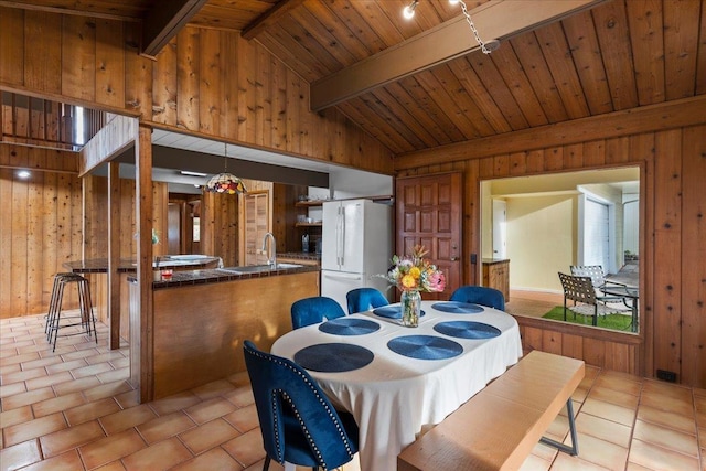 tiled dining space featuring wooden ceiling, lofted ceiling with beams, and wood walls