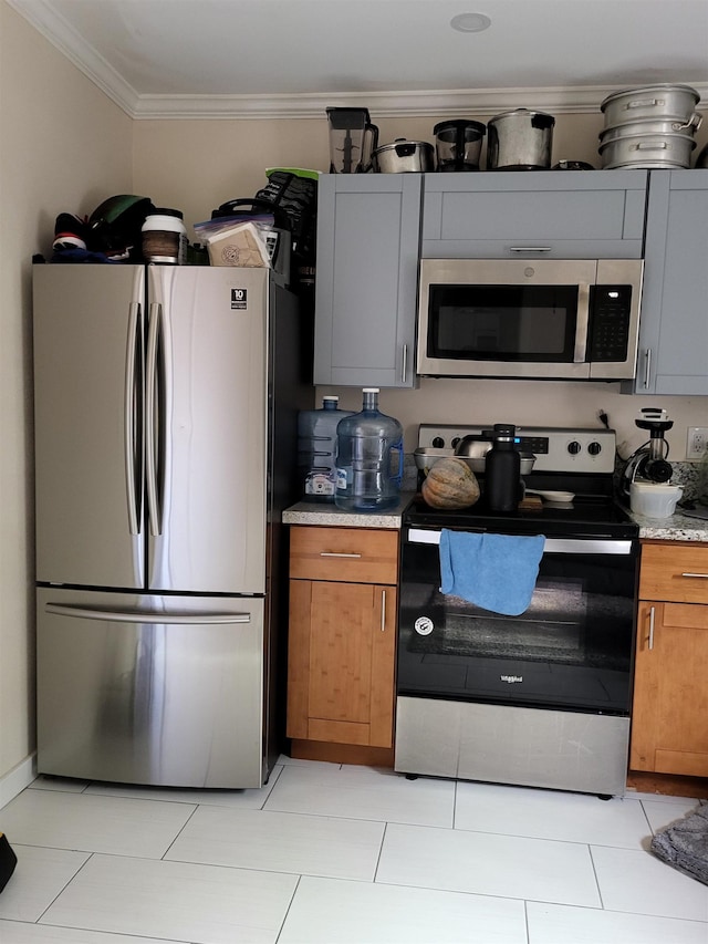 2170 Kahookele St, Wailuku, HI 96793 - kitchen featuring light countertops, crown molding, light tile patterned floors, stainless steel appliances, and brown cabinetry