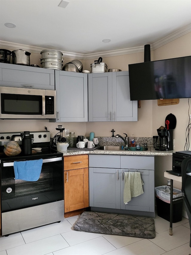 2170 Kahookele St, Wailuku, HI 96793 - kitchen with light countertops, ornamental molding, stainless steel appliances, a sink, and brown cabinetry