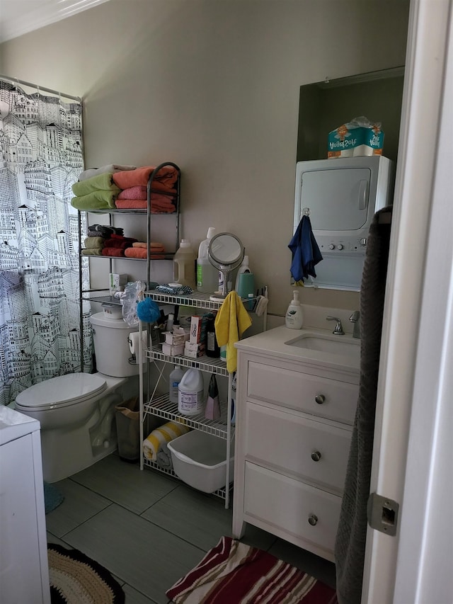 2170 Kahookele St, Wailuku, HI 96793 - bathroom with stacked washer and clothes dryer, toilet, a shower with shower curtain, and vanity