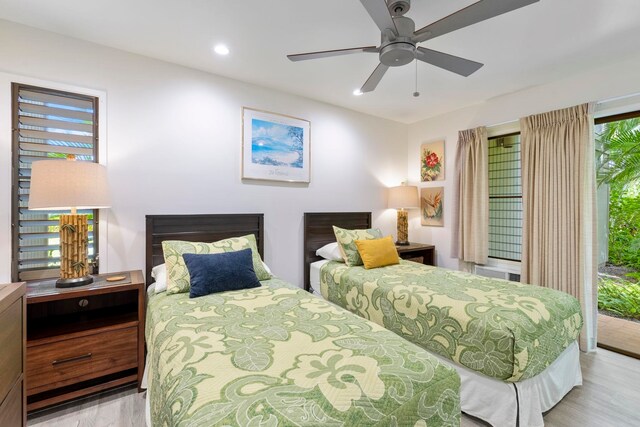 bedroom featuring ceiling fan, light wood-type flooring, access to outside, and multiple windows