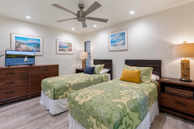 bedroom with light hardwood / wood-style floors and ceiling fan