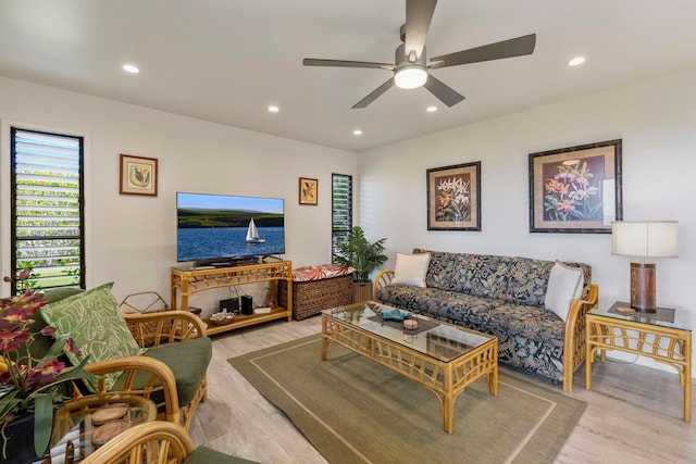 living room featuring light hardwood / wood-style floors and ceiling fan