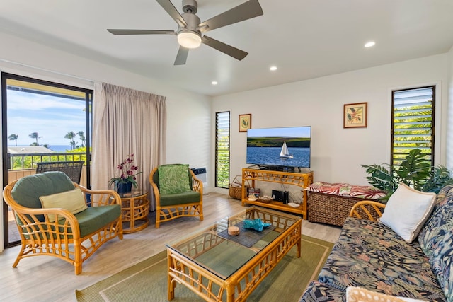 living room featuring ceiling fan and light hardwood / wood-style floors