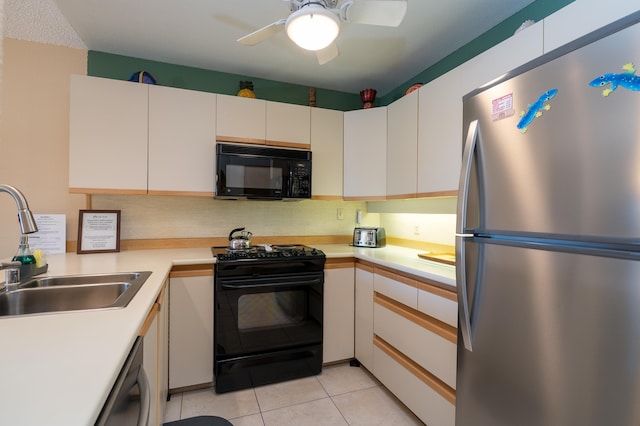 kitchen with ceiling fan, sink, black appliances, light tile patterned floors, and white cabinets