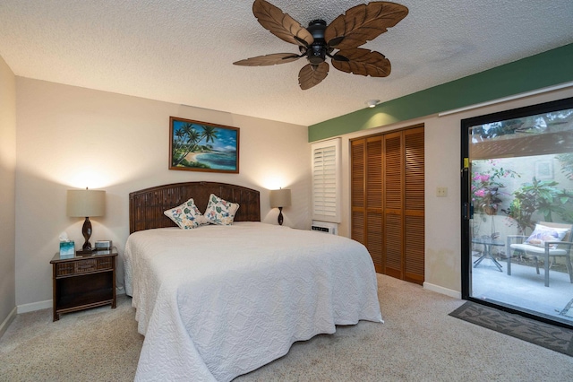 carpeted bedroom featuring access to exterior, ceiling fan, a closet, and a textured ceiling