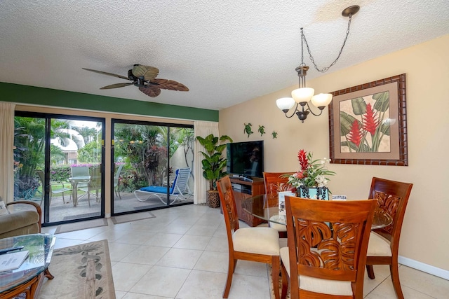 dining room with ceiling fan with notable chandelier, light tile patterned flooring, and a textured ceiling