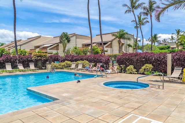 view of pool with a patio area and a hot tub