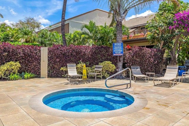 view of pool with a hot tub and a patio area