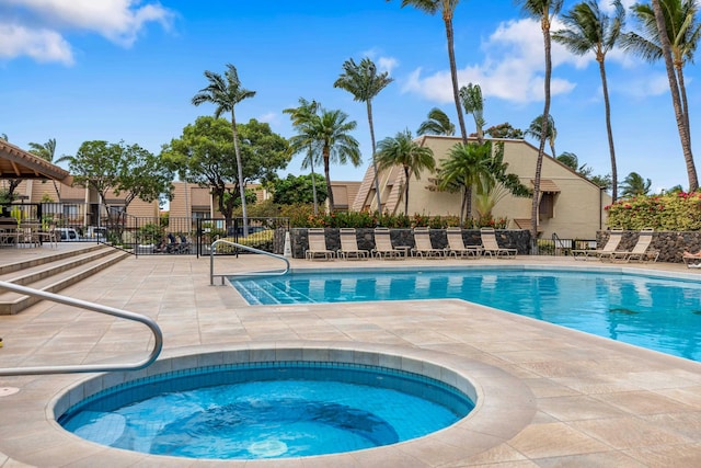 view of swimming pool featuring a community hot tub and a patio