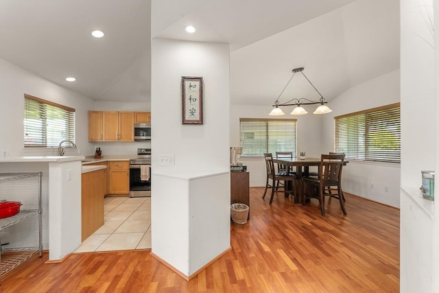 35 Emoloa Pl, Wailuku, HI 96793 - kitchen with appliances with stainless steel finishes, lofted ceiling, healthy amount of natural light, light countertops, and light wood-style floors