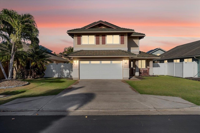 view of front of property with a yard and a garage