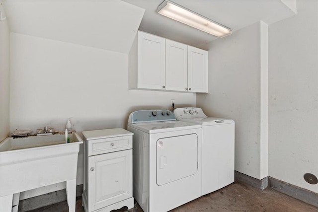 washroom featuring cabinets, washer and clothes dryer, and sink