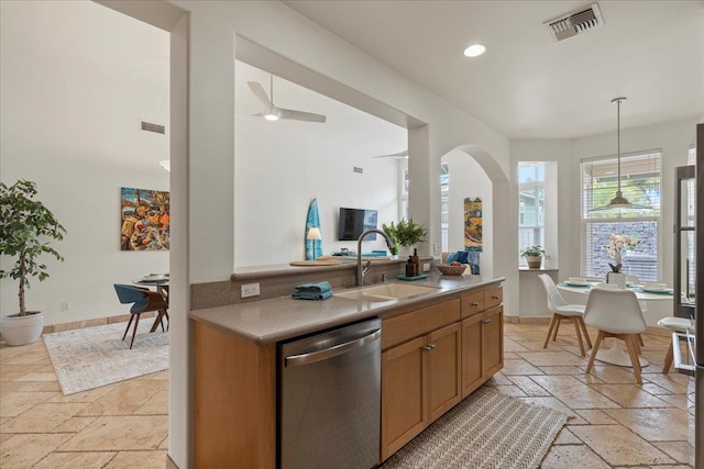 kitchen with ceiling fan, stainless steel dishwasher, hanging light fixtures, and sink