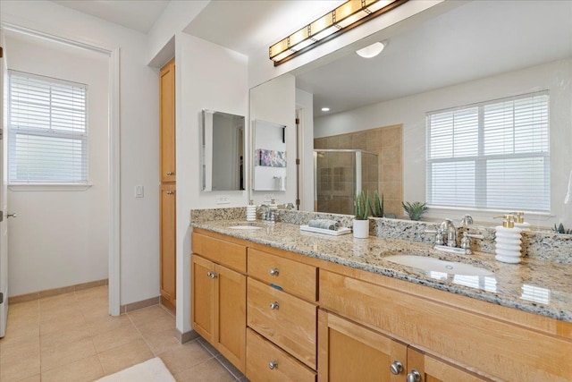 bathroom with tile patterned flooring, vanity, and a shower with shower door