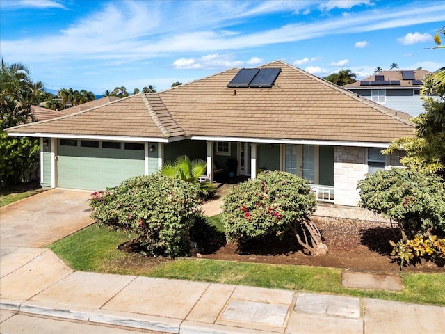 view of front of house with solar panels and a garage