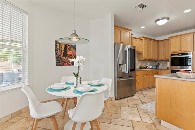 kitchen featuring backsplash, stainless steel appliances, and hanging light fixtures