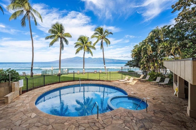 view of swimming pool featuring a water and mountain view and a patio