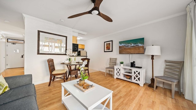 living room featuring ornamental molding, ceiling fan, and light hardwood / wood-style floors