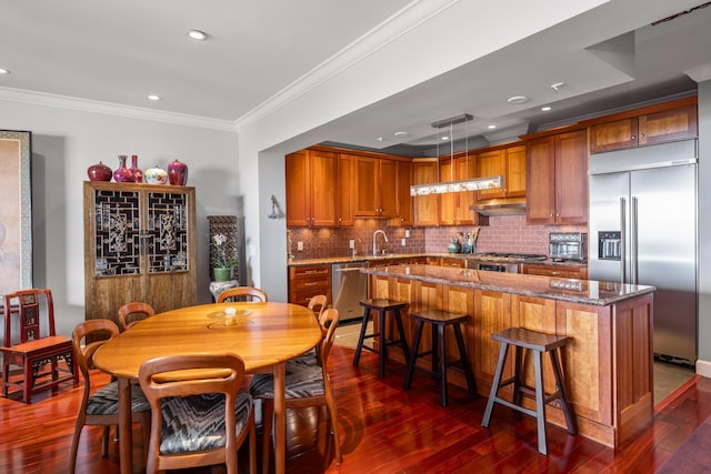 dining space featuring crown molding, sink, and dark wood-type flooring