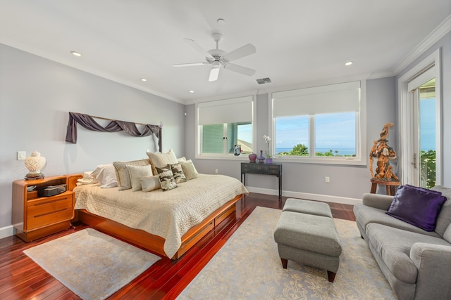 bedroom featuring wood-type flooring, a water view, ceiling fan, and ornamental molding