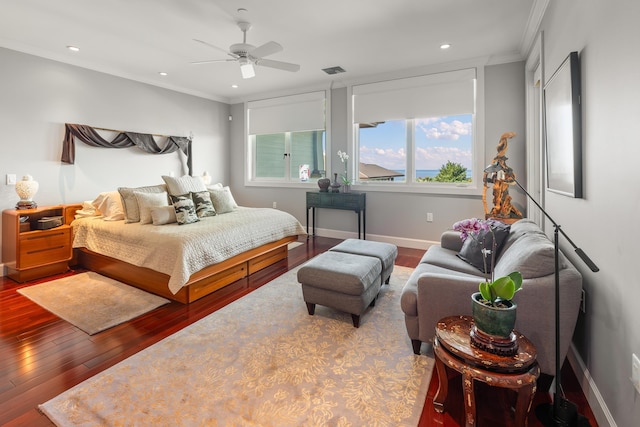 bedroom featuring ceiling fan, hardwood / wood-style floors, and ornamental molding