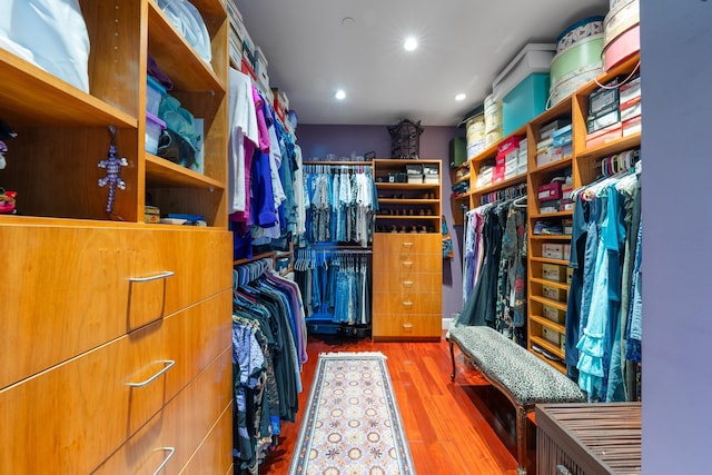 walk in closet with light wood-type flooring