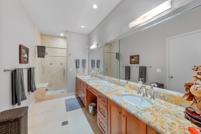 bathroom with vanity, tile patterned floors, and a shower with door