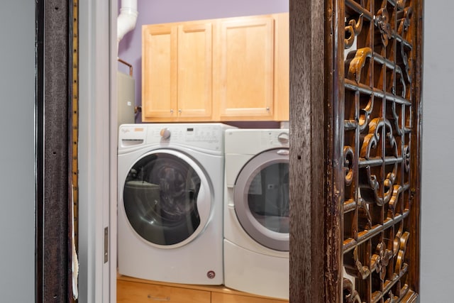 laundry area featuring cabinets and washing machine and clothes dryer