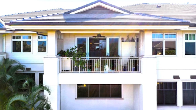 back of property featuring ceiling fan